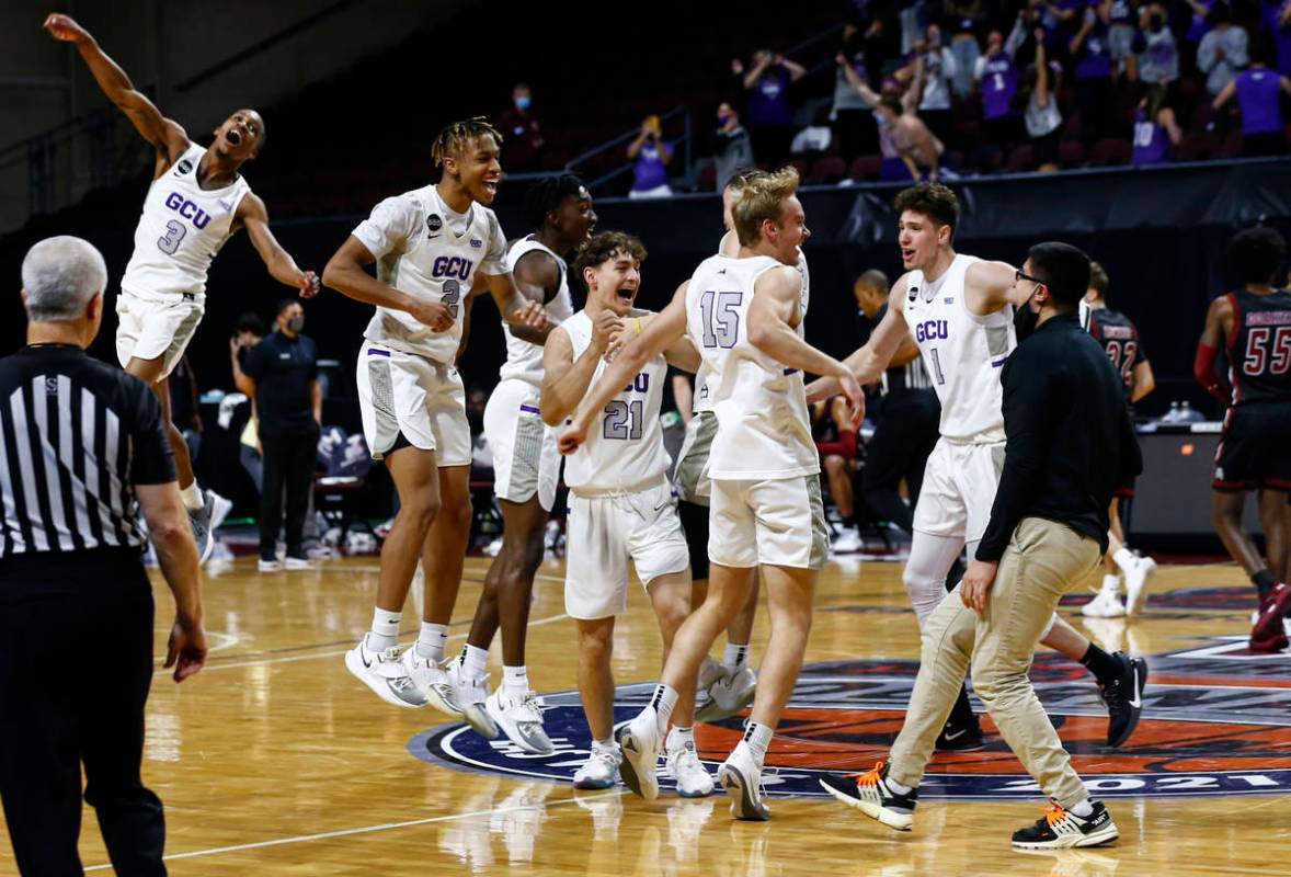 Grand Canyon players celebrate after defeating New Mexico State 74-56 in an NCAA college basket ...