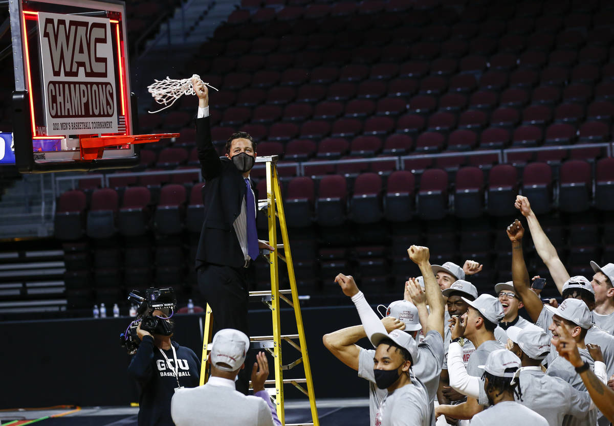 Grand Canyon coach Bryce Drew holds up the net after the team defeated New Mexico State 74-56 i ...