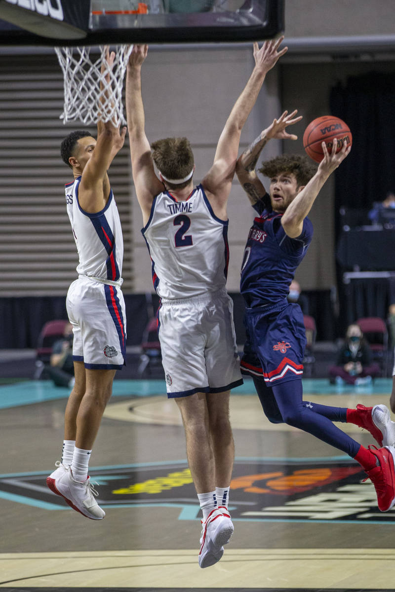 A shot attempt by St. Mary's Gaels guard Logan Johnson (0) is defended by Gonzaga Bulldogs forw ...