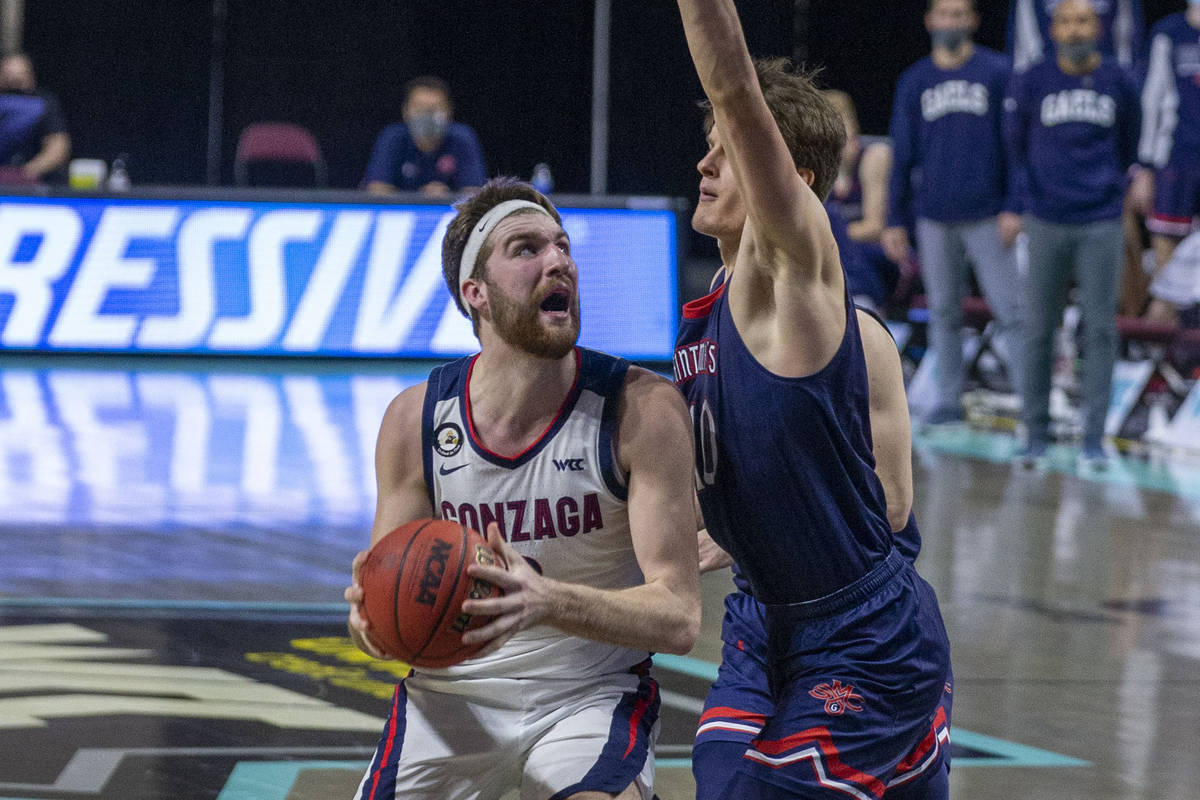 Gonzaga Bulldogs forward Drew Timme (2) looks to shoot as St. Mary's Gaels center Mitchell Saxe ...