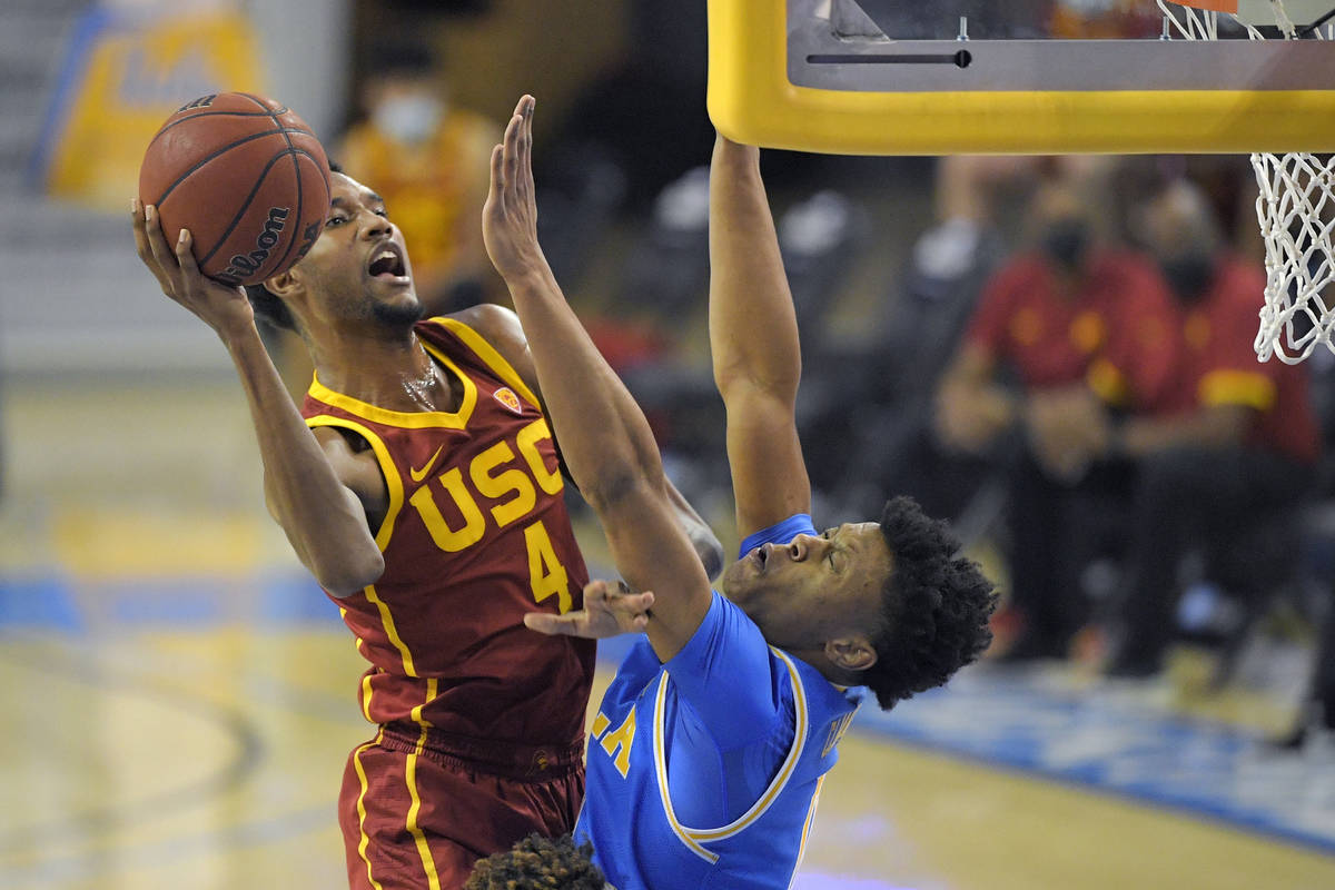 Southern California forward Evan Mobley, left, shoots as UCLA guard Jaylen Clark defends during ...