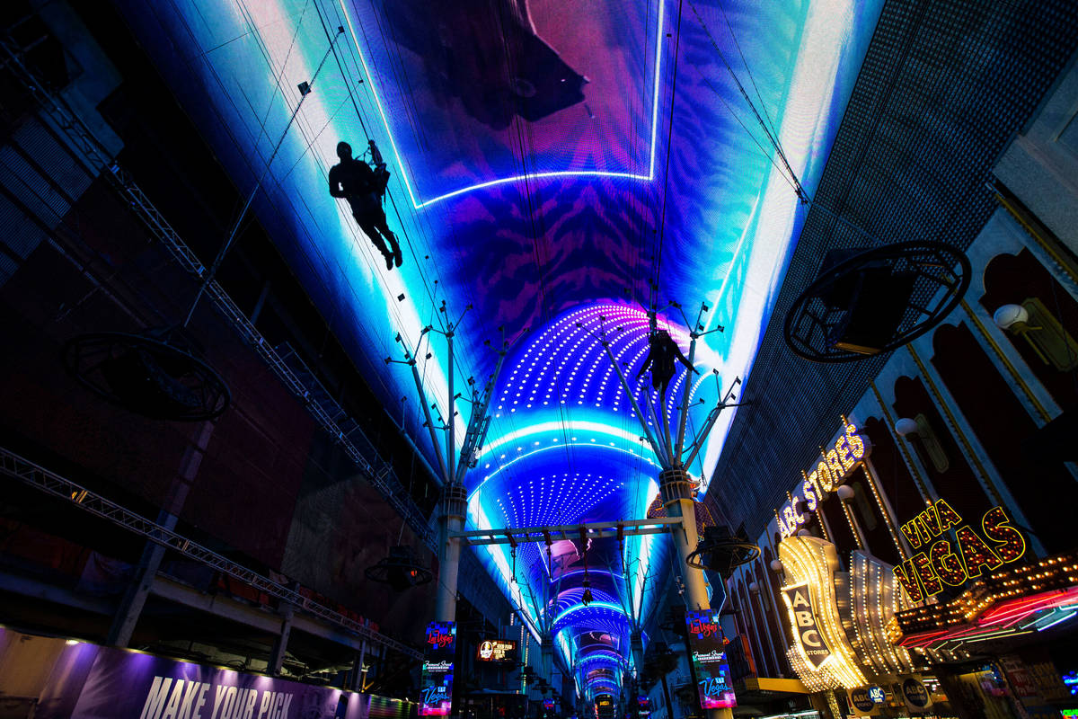 In this Dec. 19, 2019, file photo, people ride SlotZilla zip line at the Fremont Street Experi ...