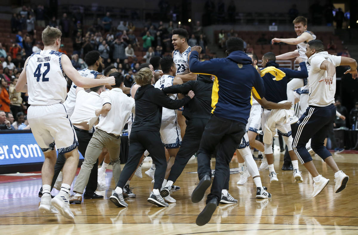 UC Irvine players celebrate after the team defeats Cal State Fullerton 92-64 during the second ...