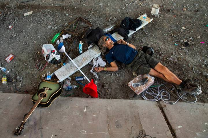 A homeless individual takes a nap beside some possessions below the Flamingo Road overpass on T ...