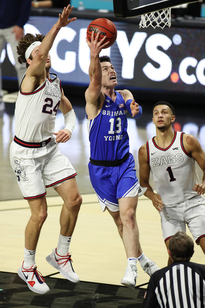 Brigham Young Cougars guard Alex Barcello (13) goes for a shot under pressure from Gonzaga Bull ...