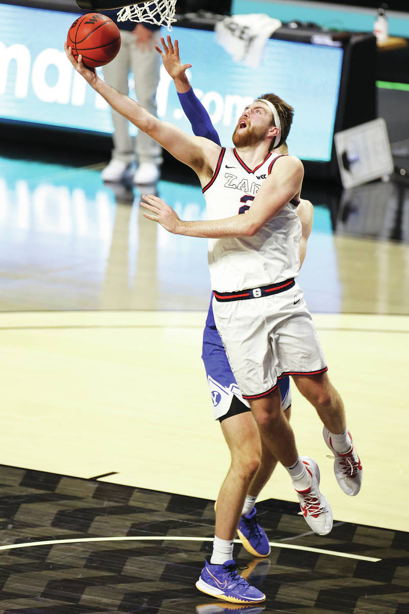Gonzaga Bulldogs forward Drew Timme (2) goes up for a shot under pressure from Brigham Young Co ...
