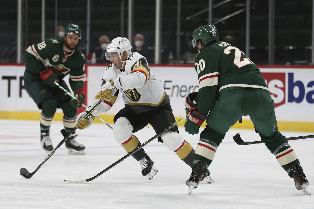 Vegas Golden Knights' Jonathan Marchessault (81) controls the puck against Minnesota Wild's Rya ...