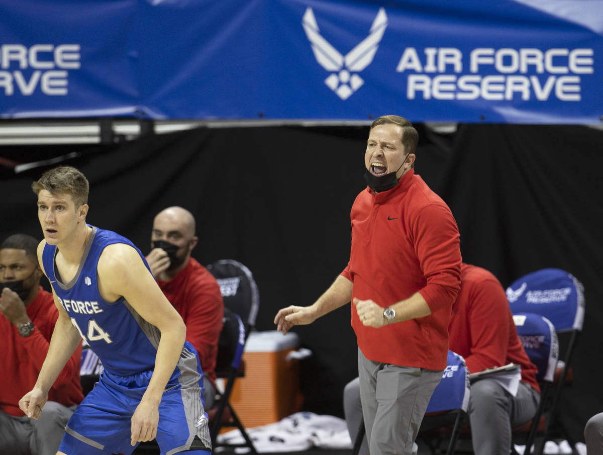 UNLV Rebels head coach T.J. Otzelberger, right, calls a defensive play in the first half during ...