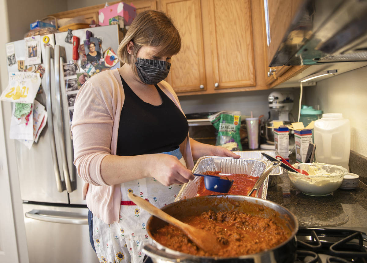 Amy Kelly makes lasagne as part of the Lasagne Love program, which provides food to those in ne ...