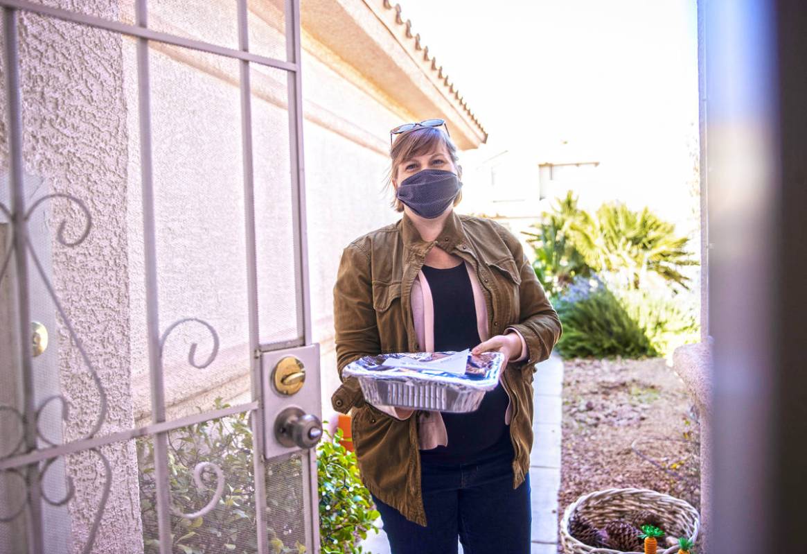 Amy Kelly delivers lasagne to a home in Las Vegas as part of the Lasagne Love program on Feb. 2 ...