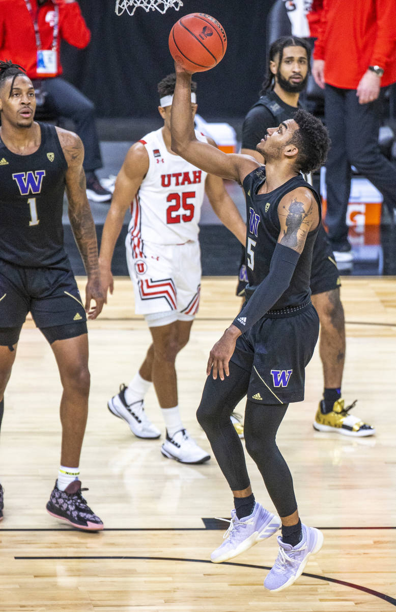Washington Huskies guard Jamal Bey (5) goes up for a basket after a foul call on the Utah Utes ...