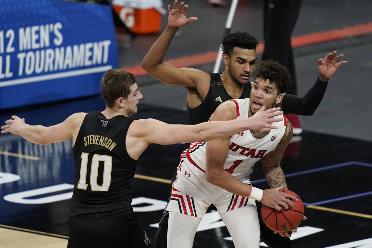 Washington's Erik Stevenson (10) and Jamal Bey guard Utah's Timmy Allen (1) during the second h ...