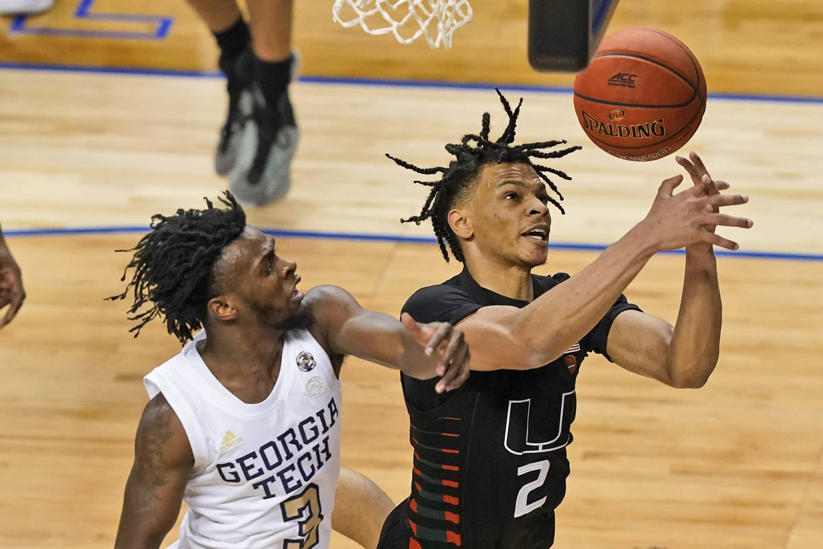 Miami guard Isaiah Wong (2) battles for a rebound with Georgia Tech guard Bubba Parham (3) duri ...