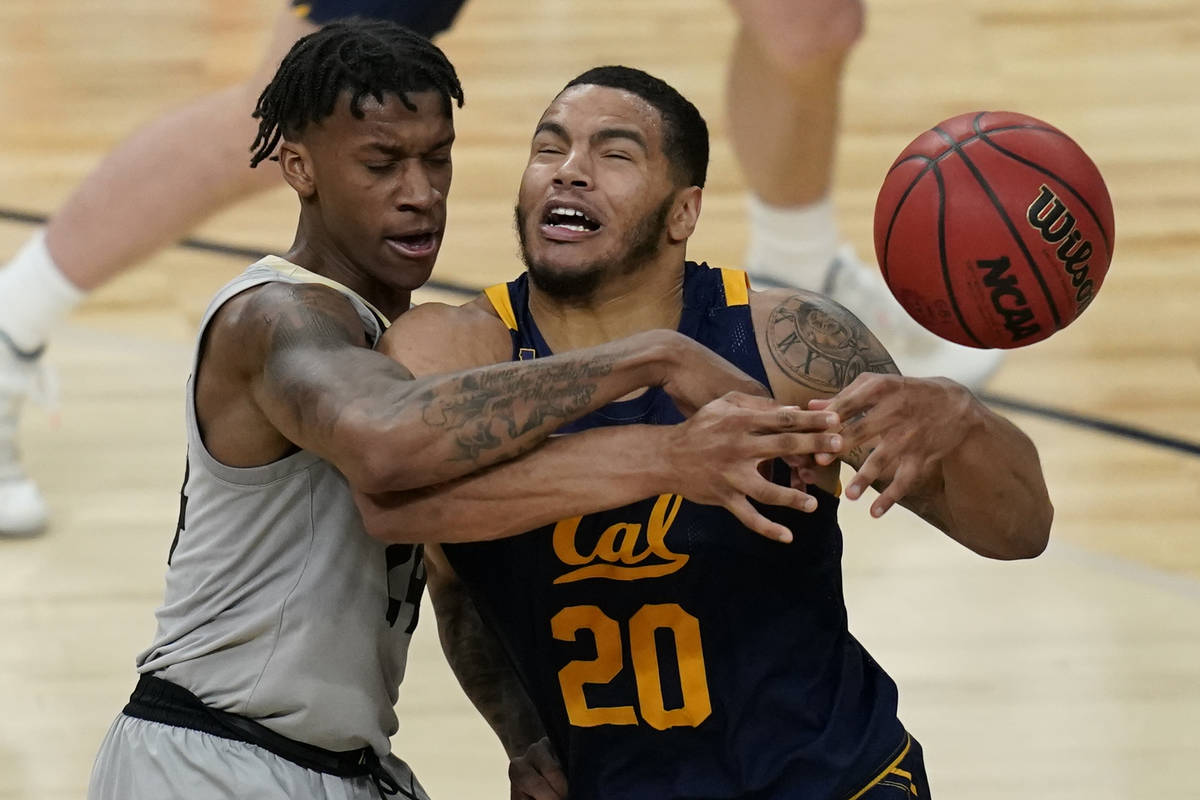 California's Matt Bradley (20) drives into Colorado's Eli Parquet (24) during the first half of ...