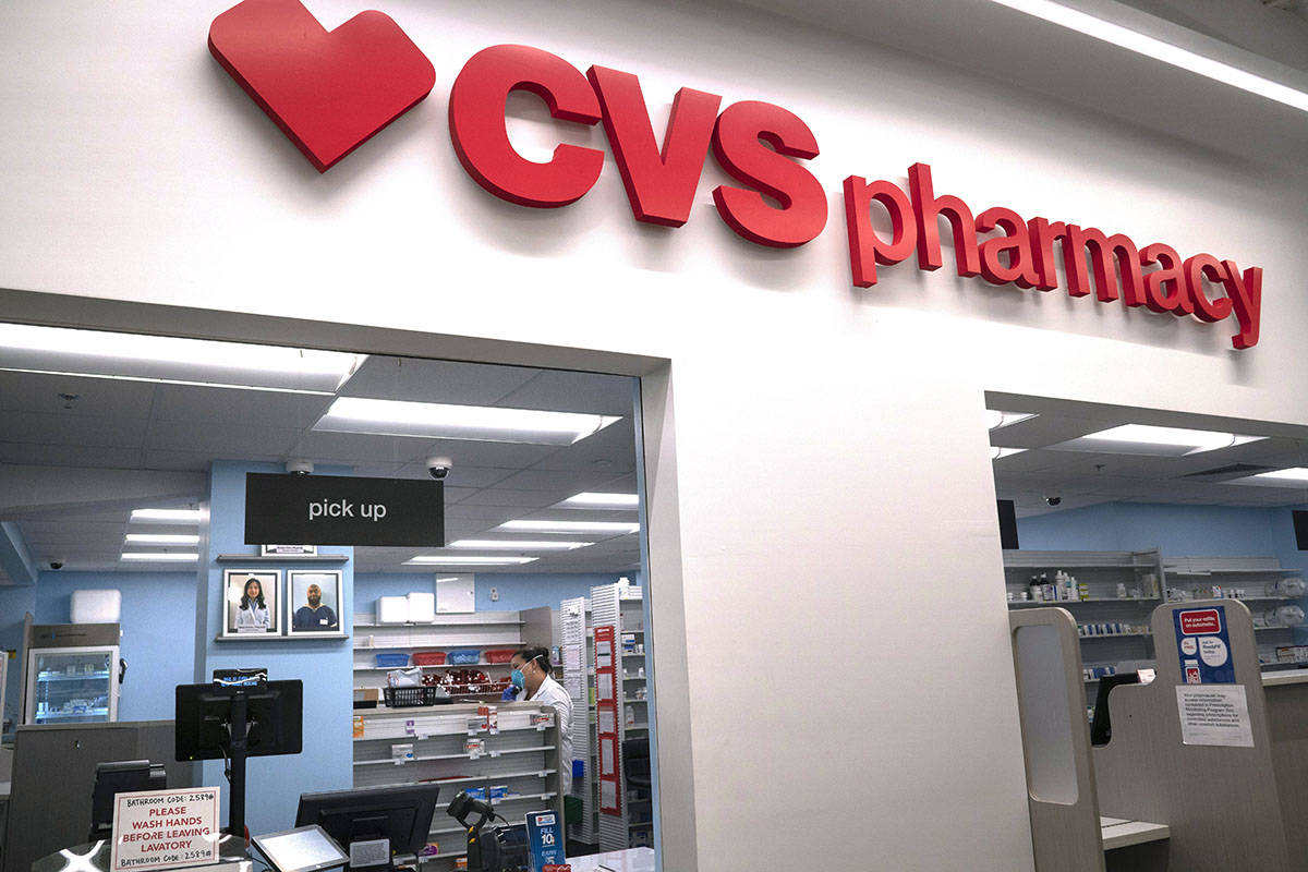 In this March 17, 2020, file photo, Pharmacist Evelyn Kim, wears a mask and gloves at the CVS p ...