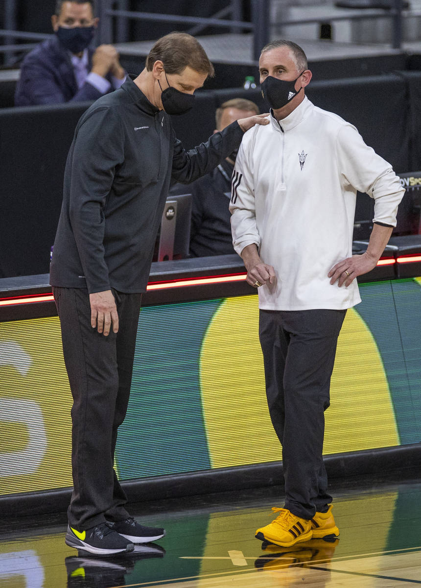Oregon Ducks head coach Dana Altman consoles Arizona State Sun Devils head coach Bobby Hurley f ...
