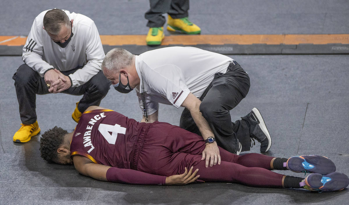 Arizona State Sun Devils forward Kimani Lawrence (4) is attended to by medical personnel after ...
