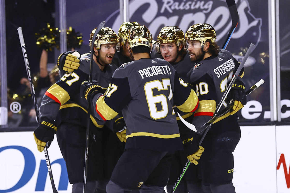 Golden Knights center Cody Glass, fourth from left, celebrates his goal against the Minnesota W ...