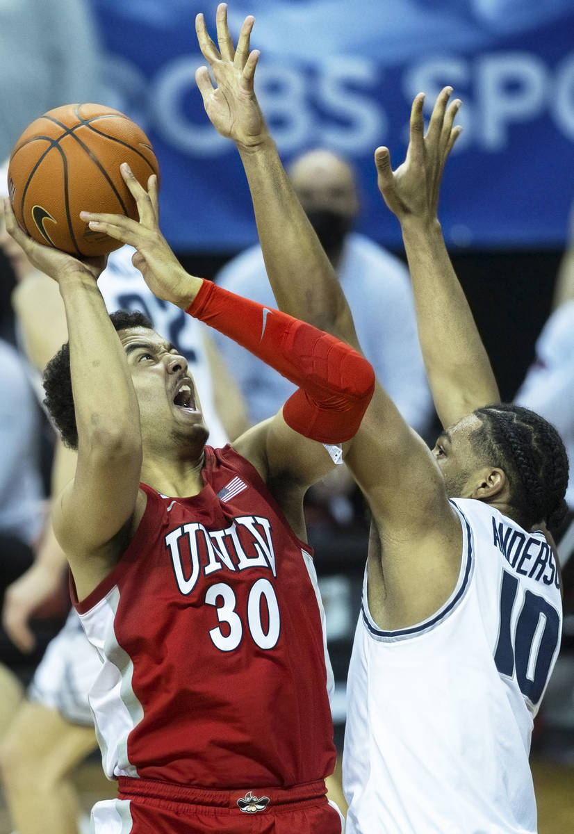 UNLV Rebels forward Devin Tillis (30) drives past Utah State Aggies forward Alphonso Anderson ( ...