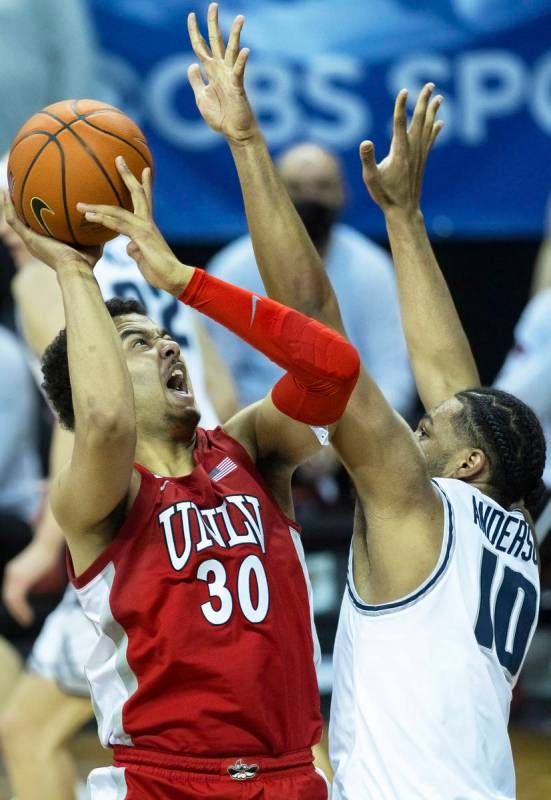 UNLV Rebels forward Devin Tillis (30) drives past Utah State Aggies forward Alphonso Anderson ( ...