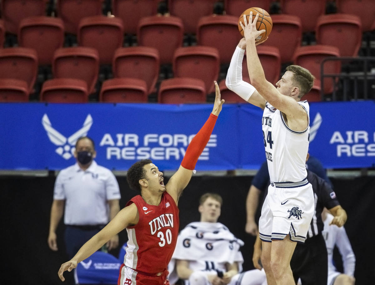 Utah State Aggies forward Justin Bean (34) shoots over UNLV Rebels forward Devin Tillis (30) in ...