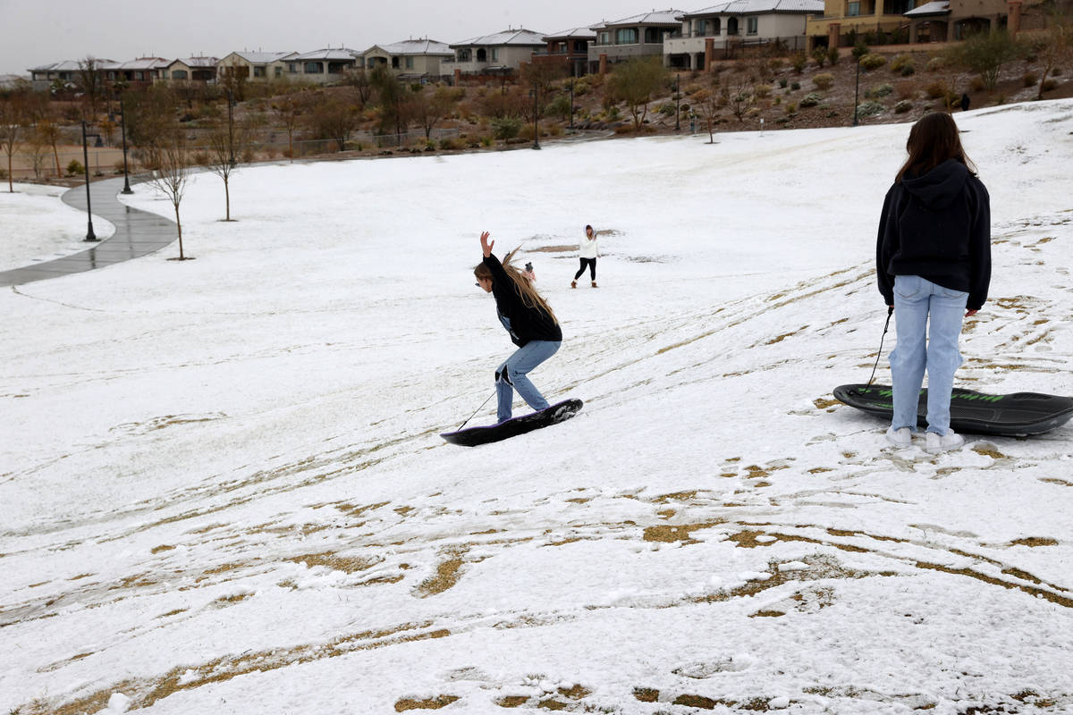 Phoebe Lee, 14, left, and Giselle Ornelas-Emerick, 13, both of Las Vegas, play in the snow at F ...