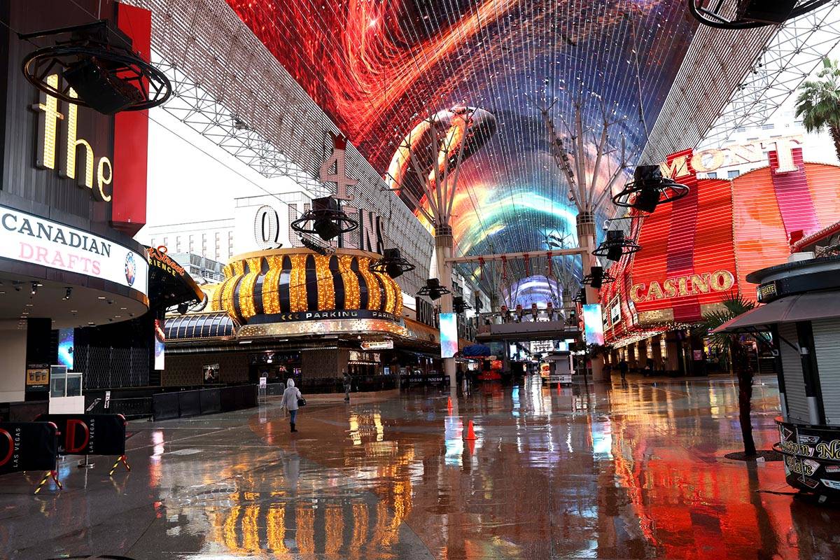 A light rain falls at the Fremont Street Experience in downtown Las Vegas Friday, March 12, 202 ...