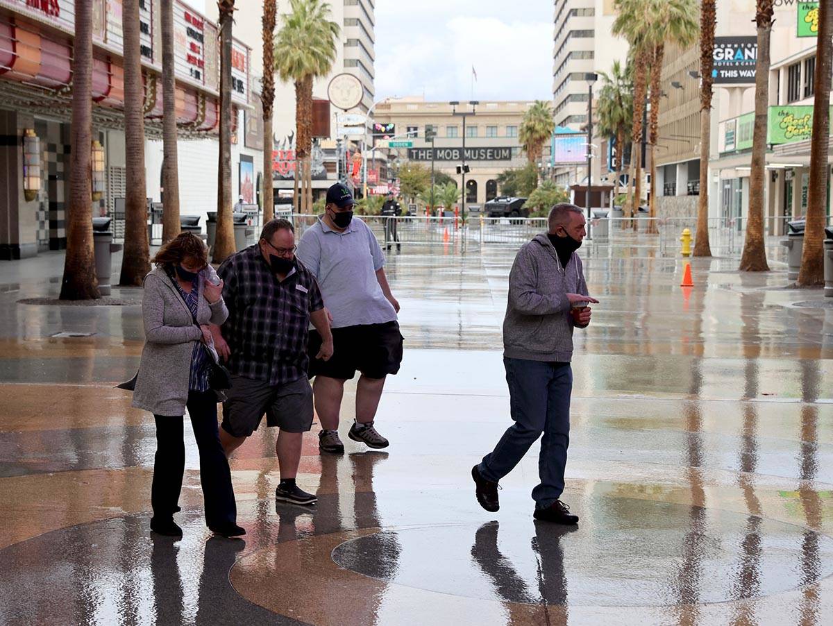 A light rain falls at the Fremont Street Experience in downtown Las Vegas Friday, March 12, 202 ...