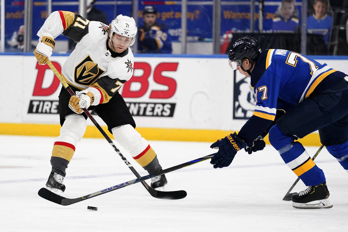 Vegas Golden Knights' William Karlsson (71) passes around St. Louis Blues' Niko Mikkola (77) du ...