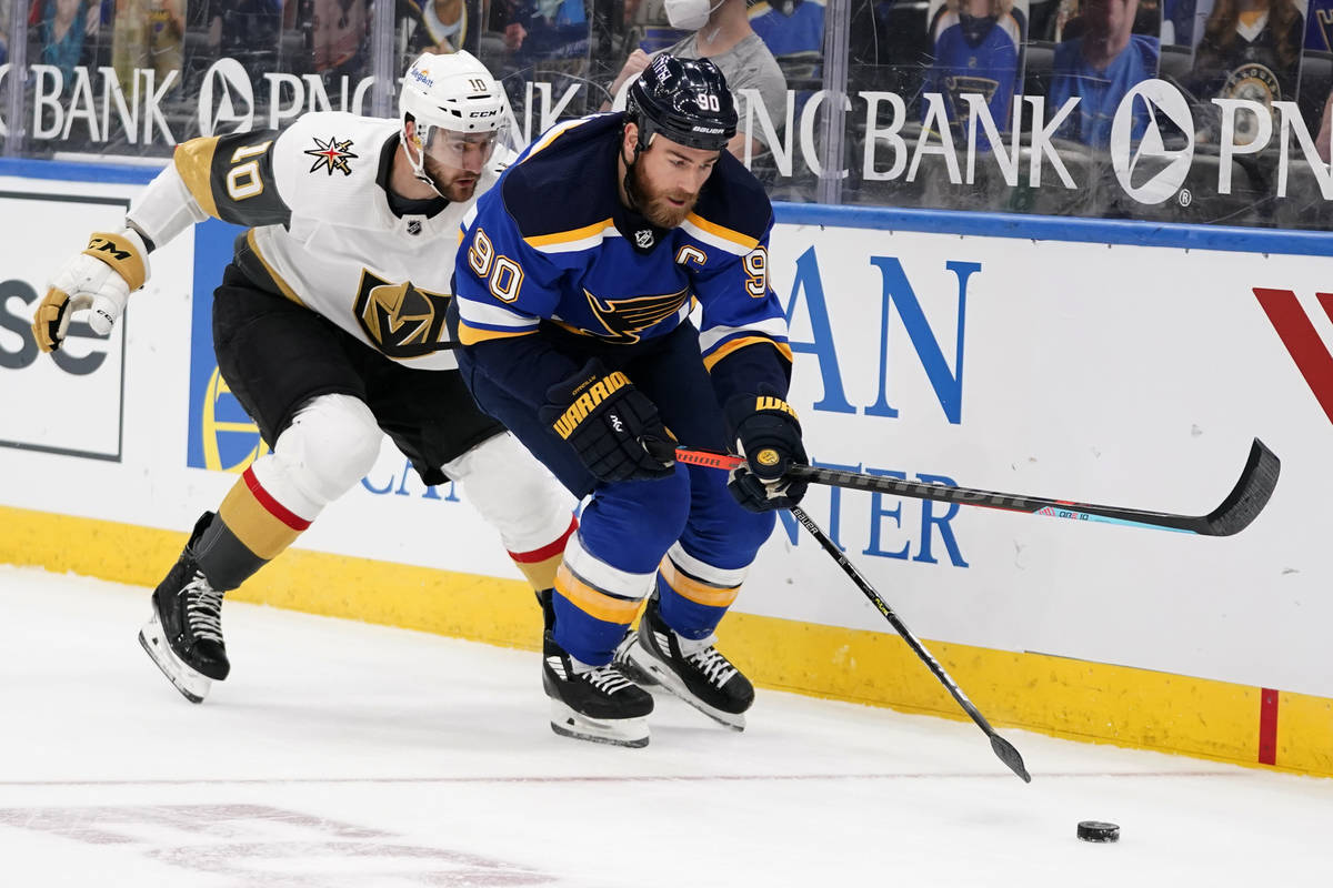 St. Louis Blues' Ryan O'Reilly (90) and Vegas Golden Knights' Nicolas Roy (10) chase after a lo ...