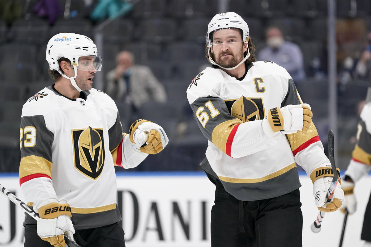 Vegas Golden Knights' Mark Stone, right, is congratulated by Alec Martinez (23) after scoring d ...