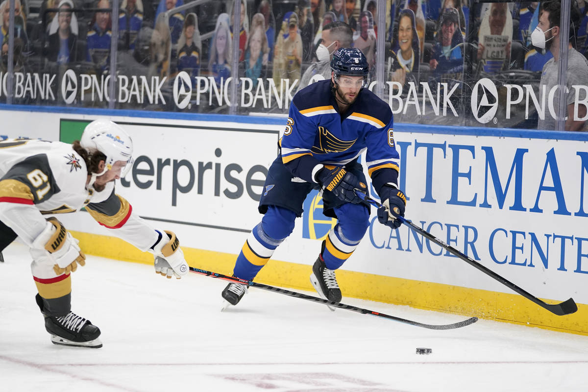 St. Louis Blues' Marco Scandella (6) and Vegas Golden Knights' Mark Stone (61) chase after a lo ...