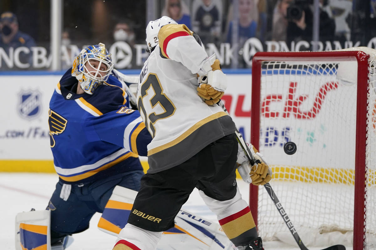 Vegas Golden Knights' Alec Martinez, right, scores past St. Louis Blues goaltender Jordan Binni ...