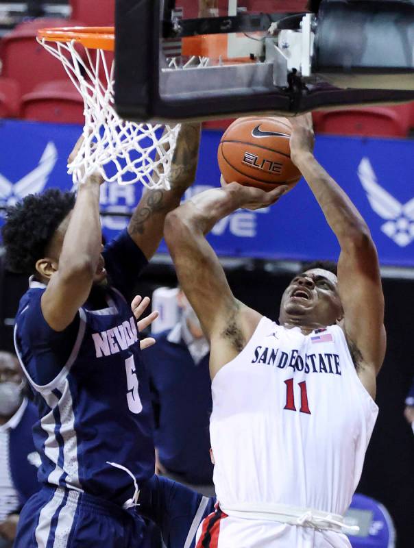 San Diego State forward Matt Mitchell (11) shoots as Nevada forward Warren Washington (5) defen ...