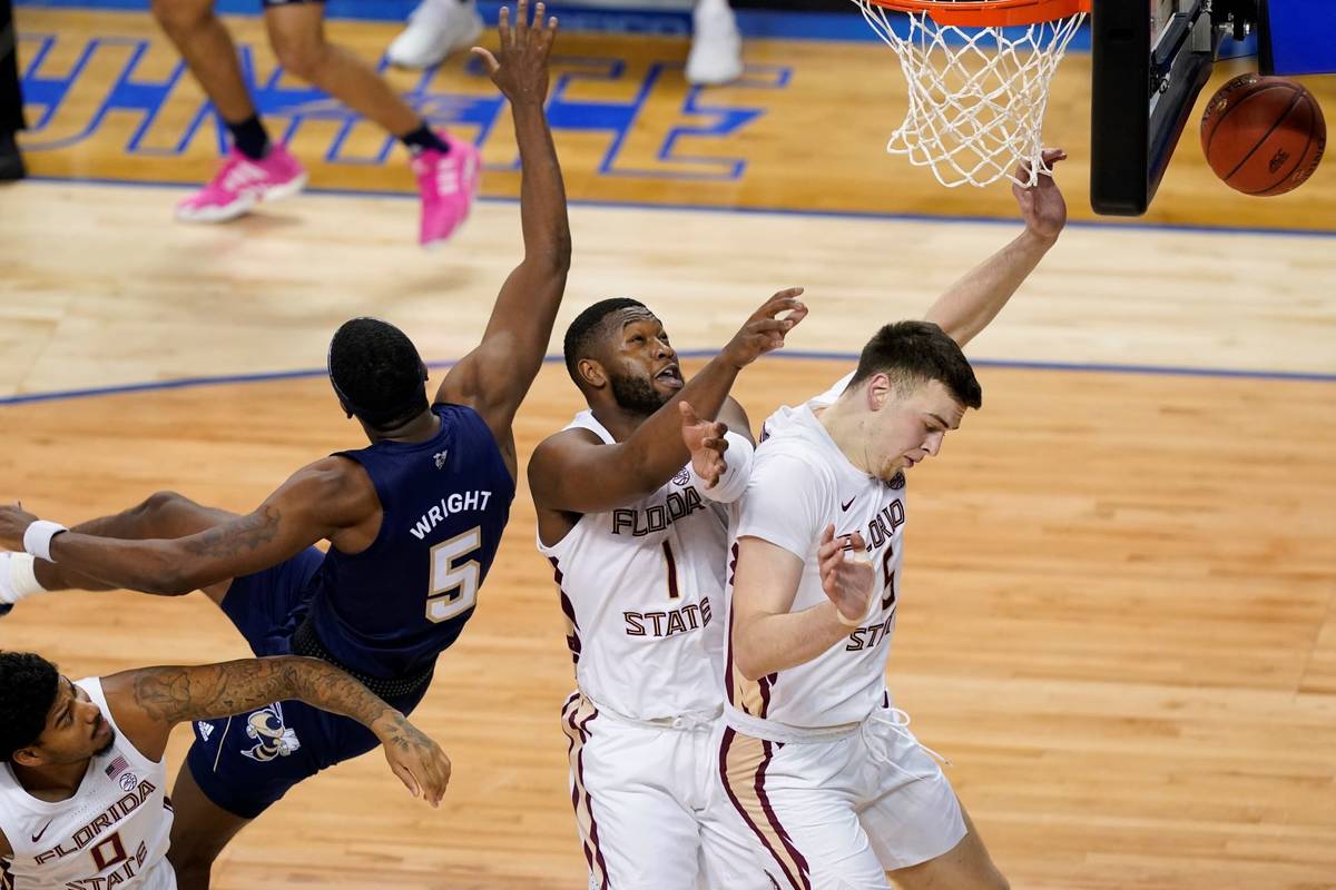 Georgia Tech forward Moses Wright (5) drives to the basket as Florida State center Balsa Kopriv ...