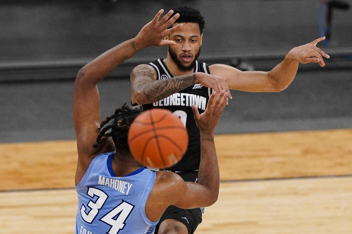 Georgetown's Jahvon Blair (0) passes away from Creighton's Denzel Mahoney (34) during the first ...