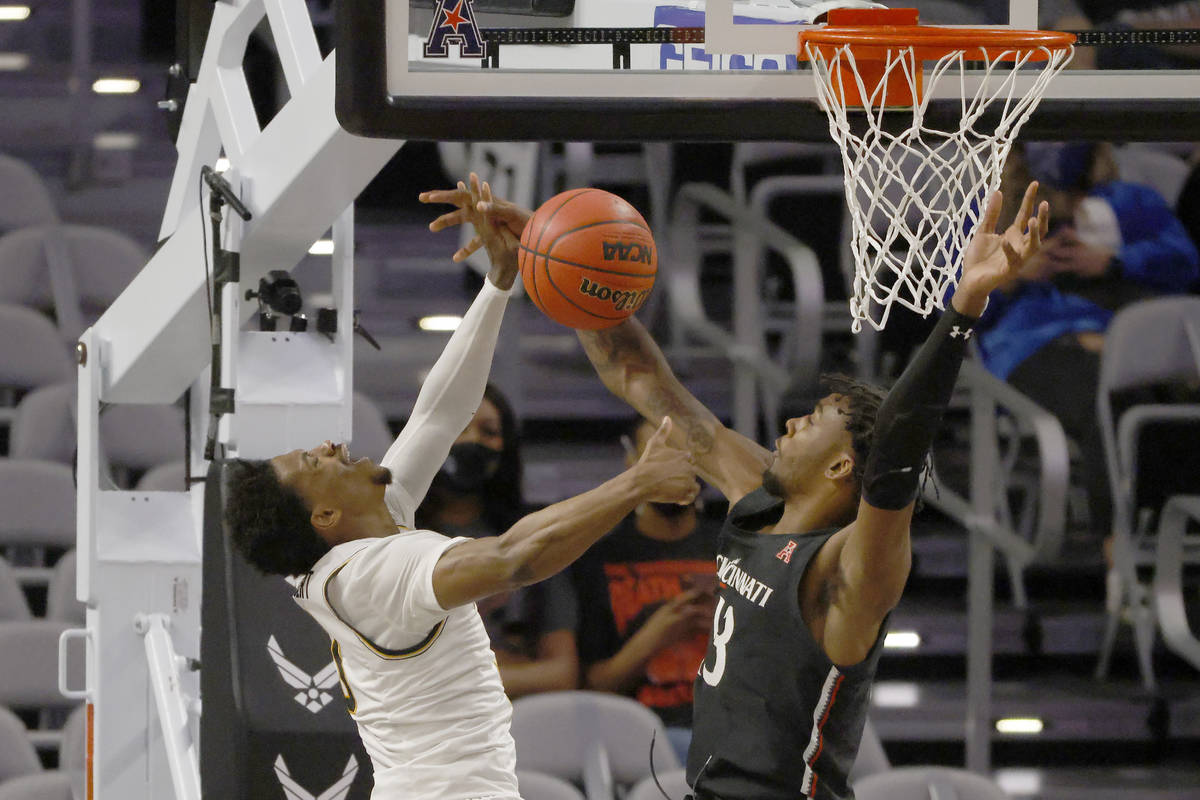 Wichita State guard Alterique Gilbert (3) and Cincinnati forward Tari Eason (13) collide under ...