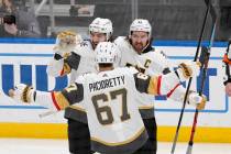Vegas Golden Knights' Mark Stone (61) is congratulated by teammates Nicolas Hague (14) and Max ...