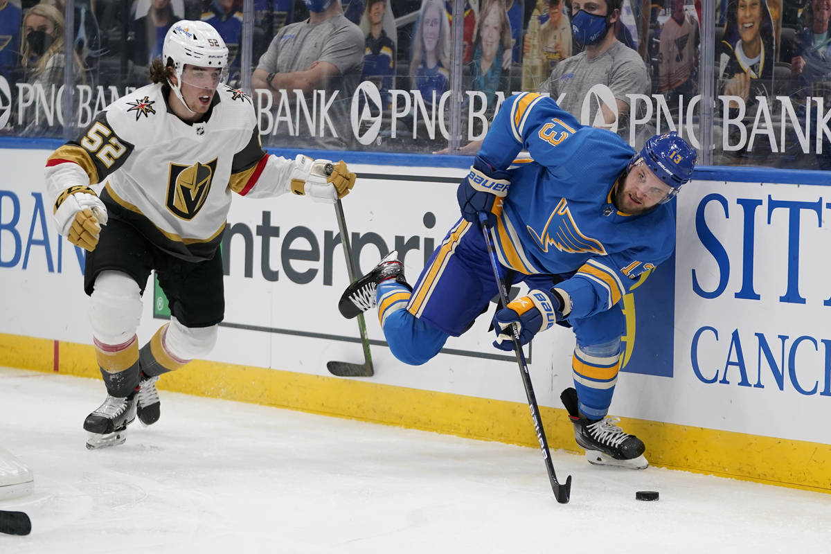 St. Louis Blues' Kyle Clifford (13) looks to pass as Vegas Golden Knights' Dylan Coghlan (52) d ...