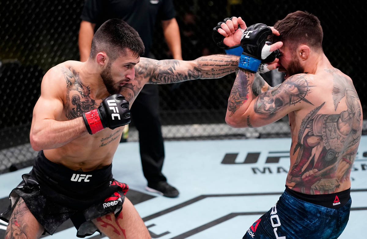 Charles Jourdain of Canada punches Marcelo Rojo of Argentina in a featherweight fight during th ...