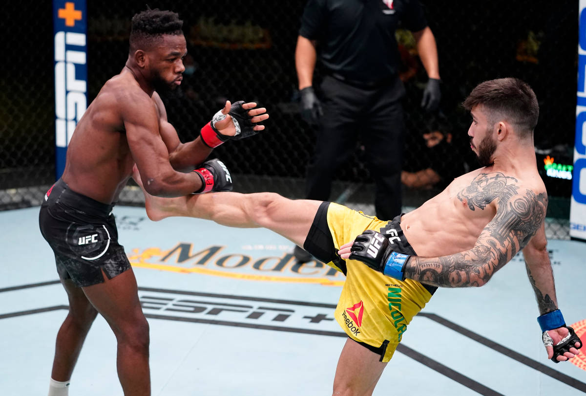 Matheus Nicolau of Brazil kicks Manel Kape of Angola in a flyweight fight during the UFC Fight ...