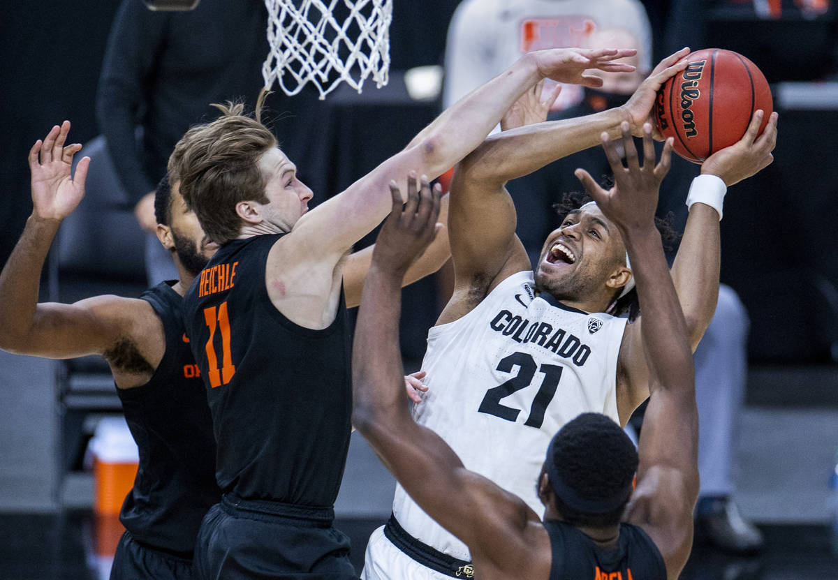 Colorado Buffaloes forward Evan Battey (21) gets off a shot under pressure from Oregon State Be ...