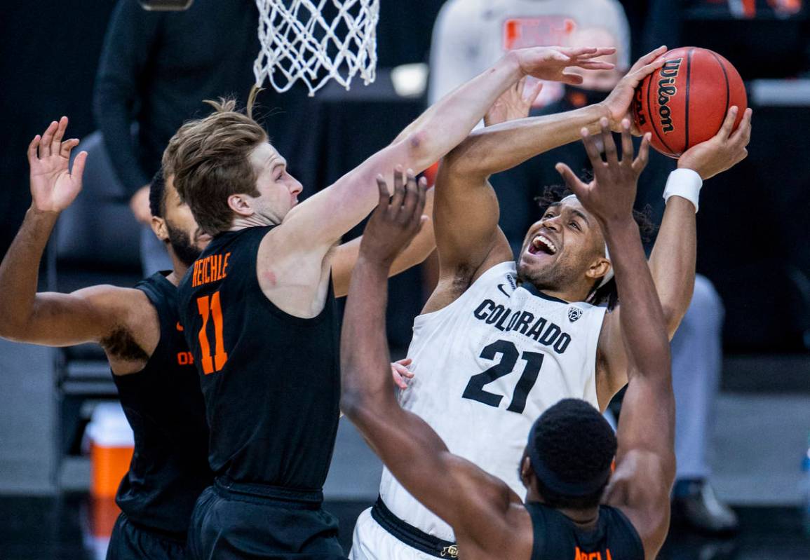 Colorado Buffaloes forward Evan Battey (21) gets off a shot under pressure from Oregon State Be ...