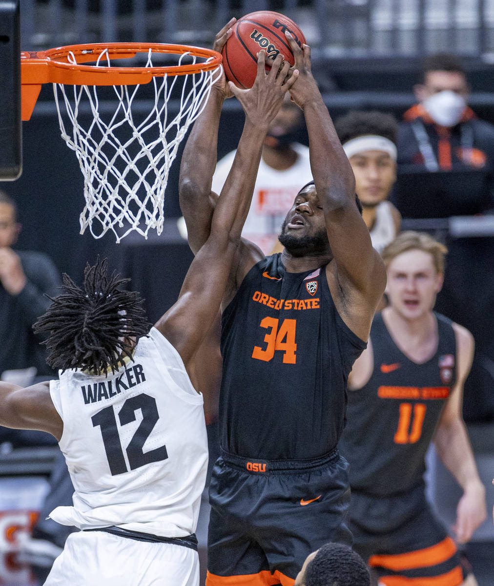 Oregon State Beavers forward Rodrigue Andela (34) elevates for a strong rebound over Colorado B ...