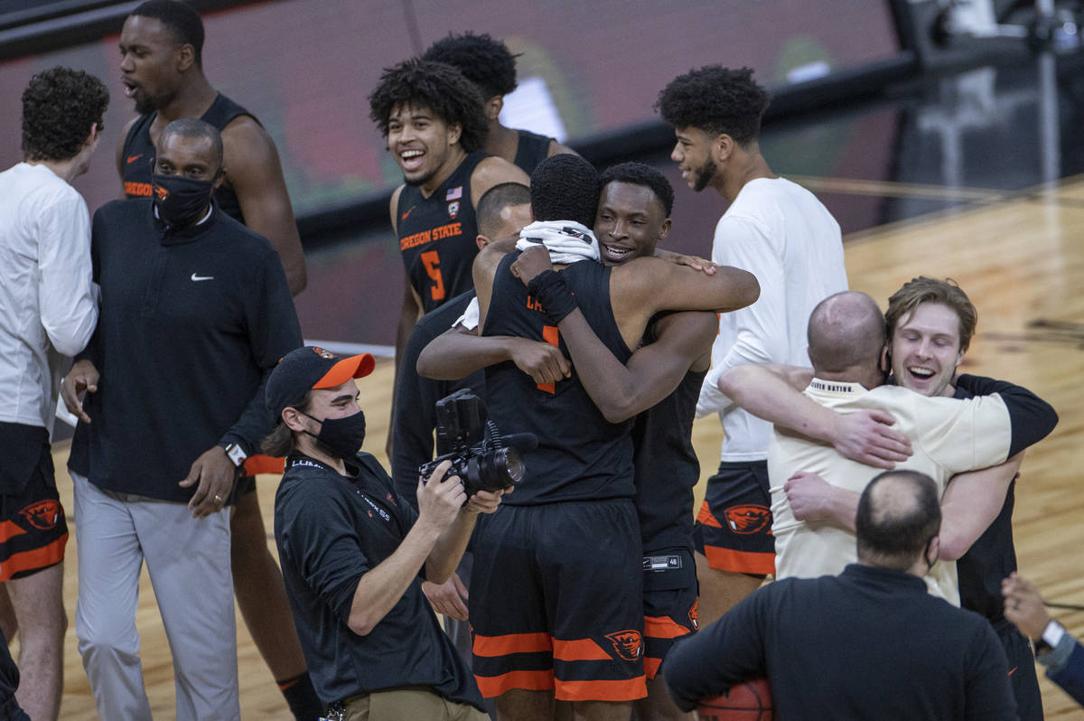 Oregon State Beavers players celebrate their win as time runs out after defeating the Colorado ...