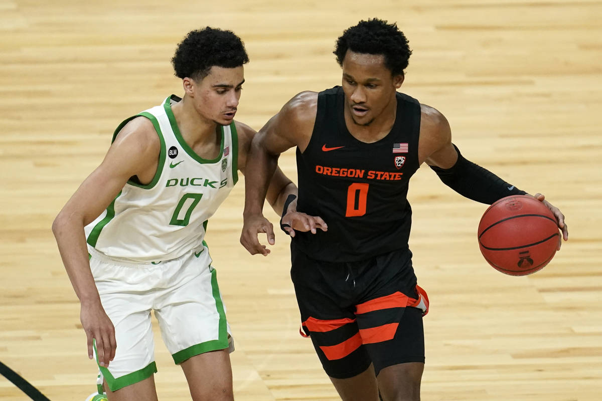 Oregon State's Gianni Hunt drives into Oregon's Will Richardson during the first half of an NCA ...