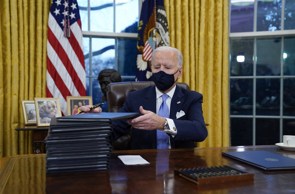 President Joe Biden signs his first executive orders. (AP Photo/Evan Vucci, File)