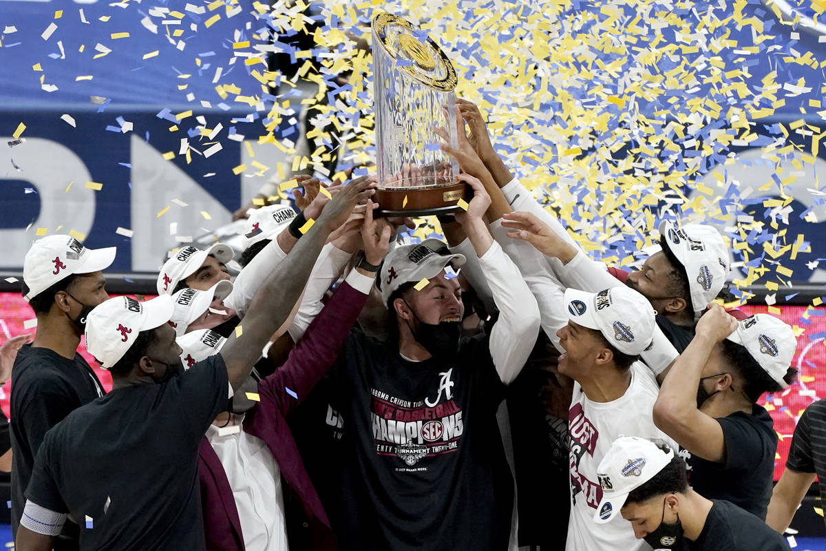 Alabama players celebrate after beating LSU in the championship game of the NCAA college basket ...