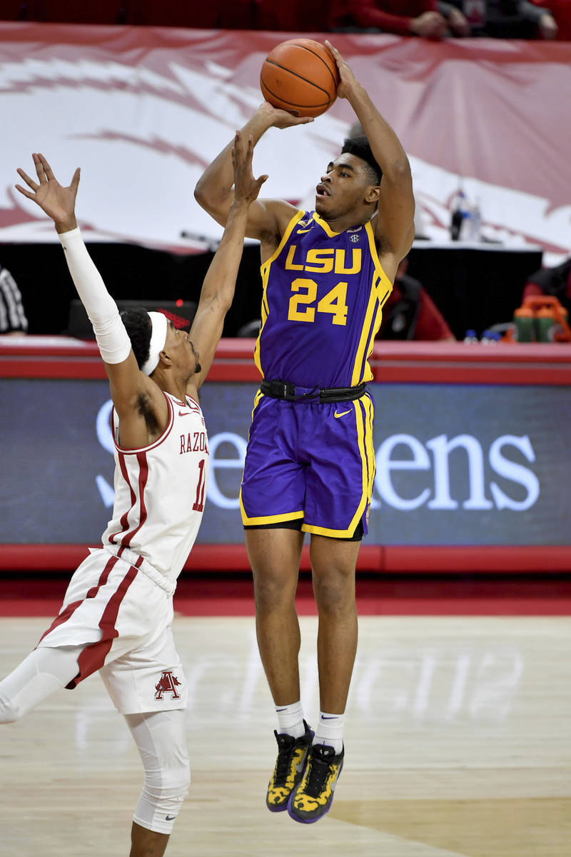 LSU guard Cameron Thomas (24) shoots over Arkansas guard Jalen Tate (11) during the second half ...