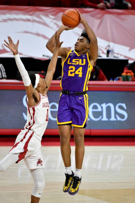 LSU guard Cameron Thomas (24) shoots over Arkansas guard Jalen Tate (11) during the second half ...